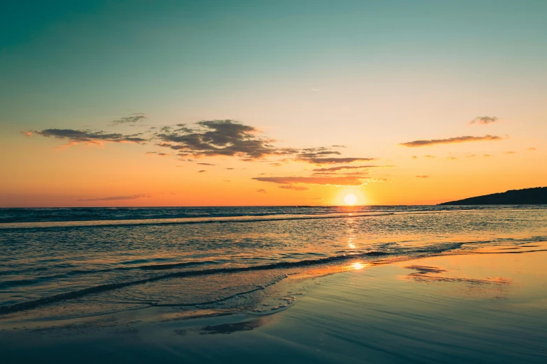 the sun is setting at the end of the day on a beach