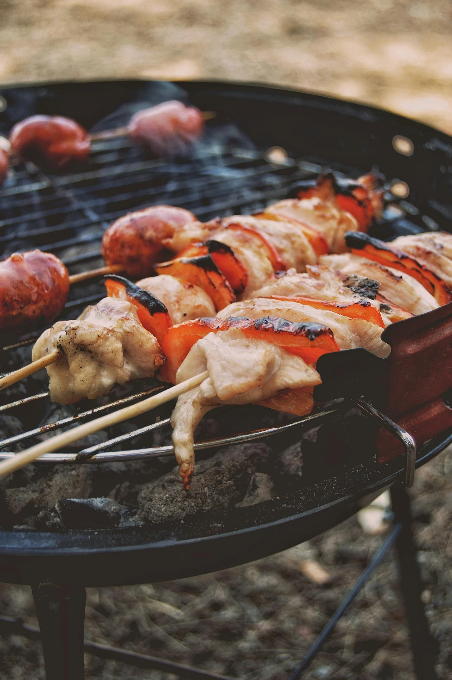 several skewers of meat on top of a grill