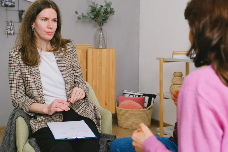 a woman talks to her little girl in her living room