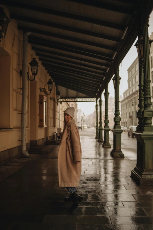 a person is walking in the rain and she has an umbrella on