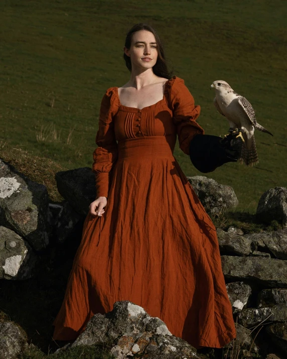 a beautiful woman in a red dress with an owl