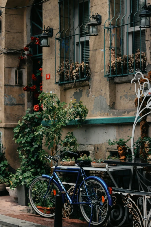 two bikes are propped up against a fence in front of a building