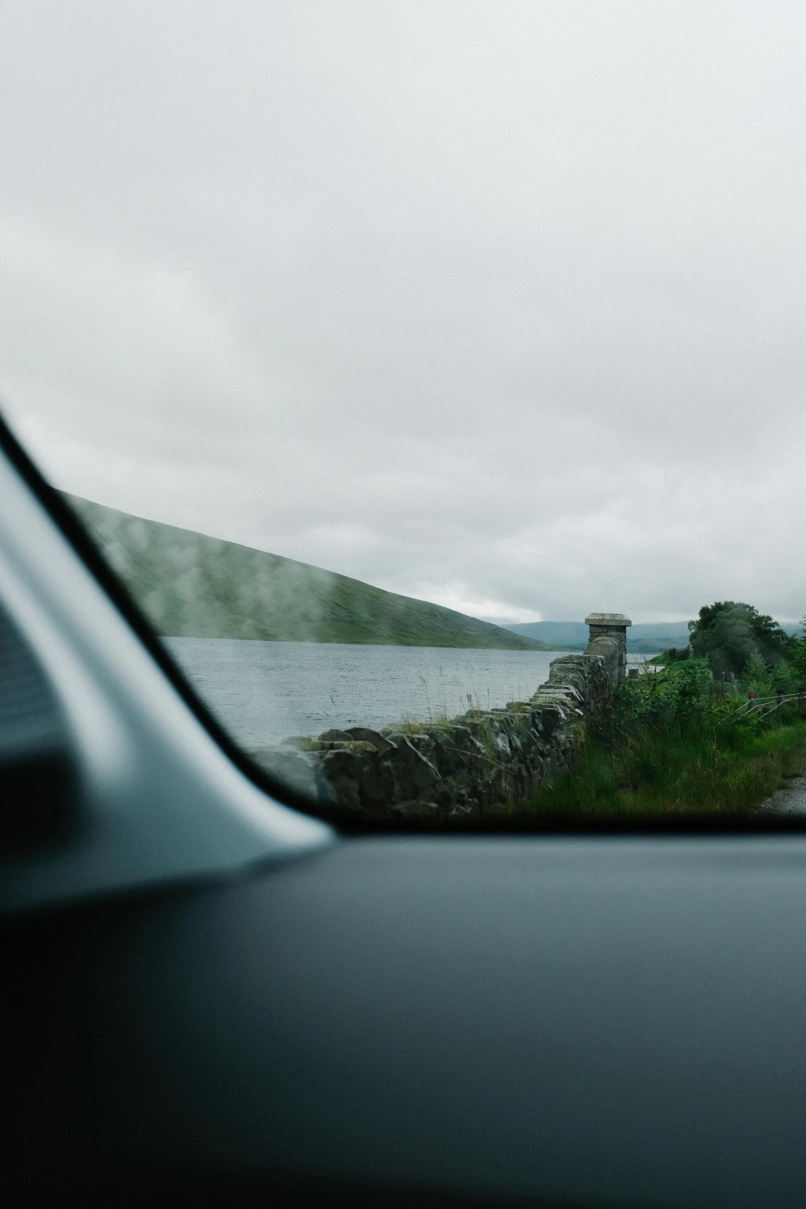 a large body of water next to a hill