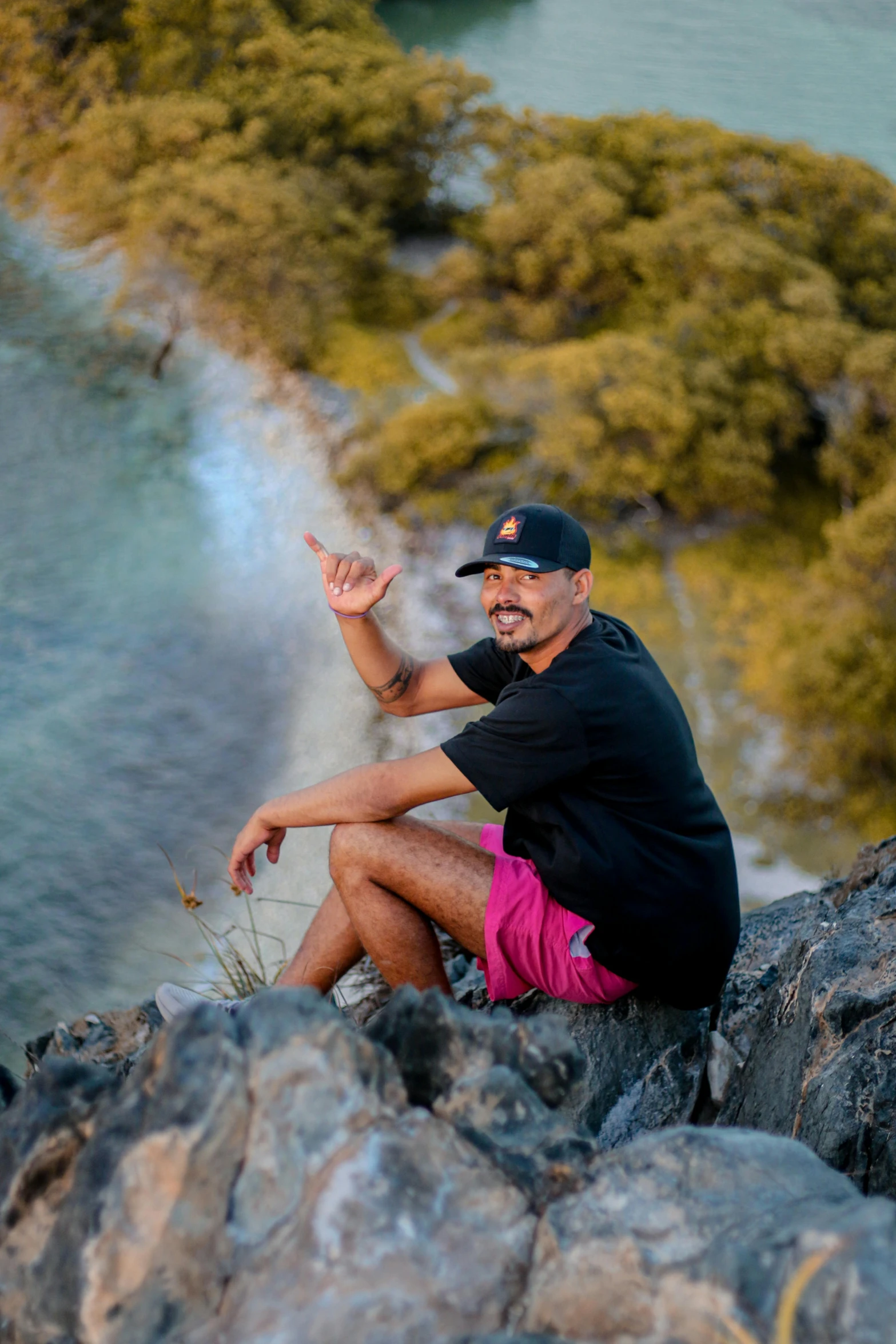 a man is on a rock near water