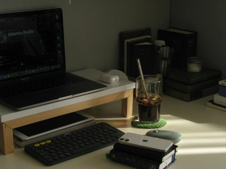 laptop and desk with glass full of alcohol
