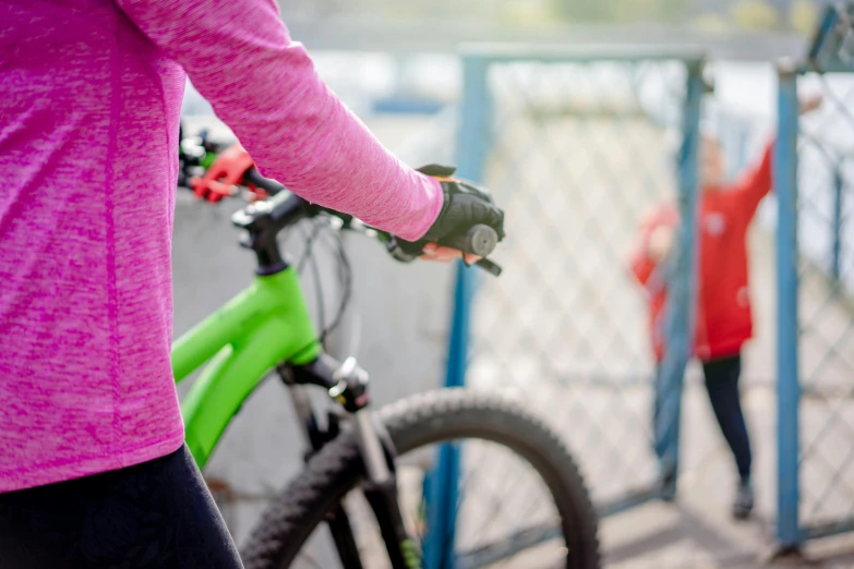 the women is riding her bike and hing her friend