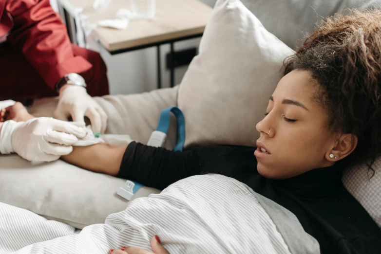 a person in a hospital bed holding a syi