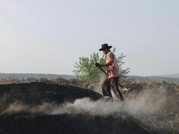 a person on a dirt hill with a brush