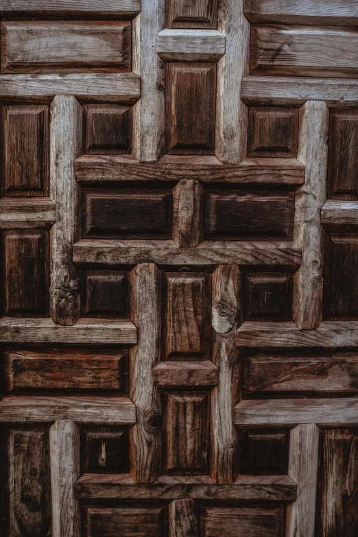 an intricate wall made of wooden blocks and bars