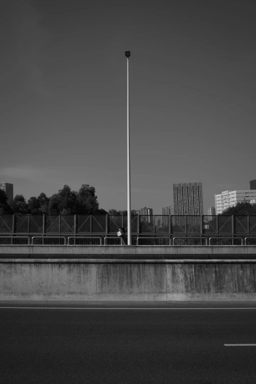 an empty city street with a pole and traffic signals