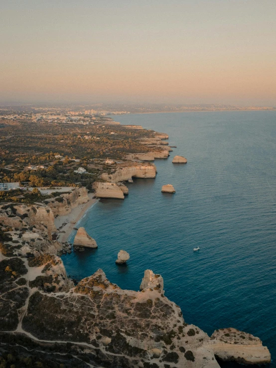 an aerial view of a large body of water near cliffs