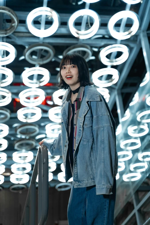 woman wearing blue pants and jacket standing near steps