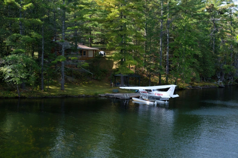 a small airplane on a runway in a lake