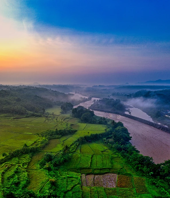 an overview of a green hilly country by the water