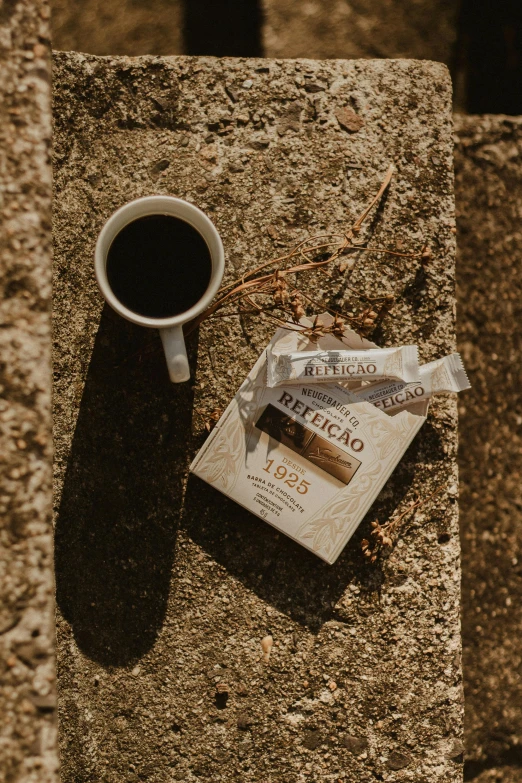 the contents of a cigarette and a cigarette pack, on the ground next to it