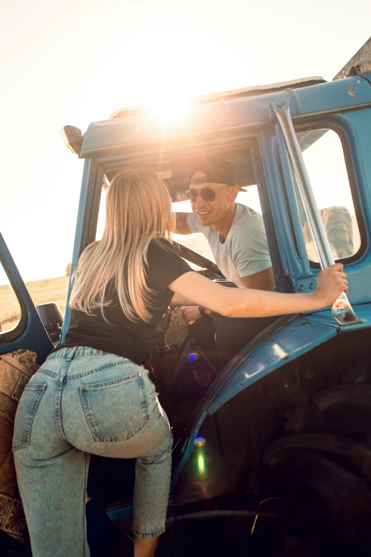 a man and woman are kissing inside a truck