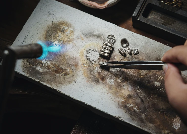 an artistic view of some silver colored items being worked on