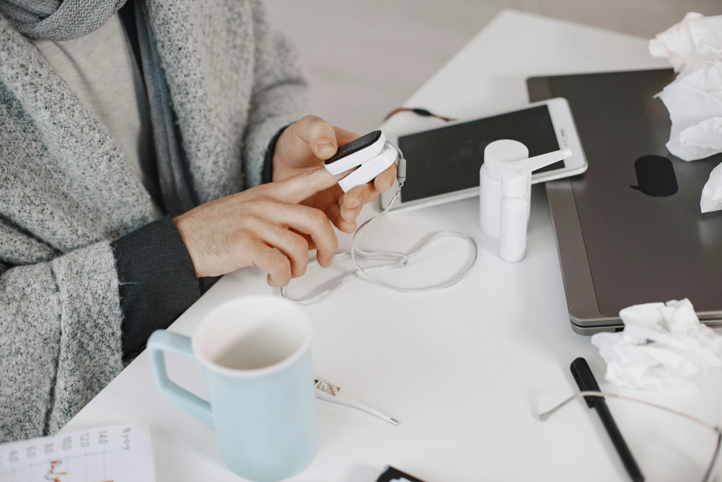 a person holding a smart phone at a table