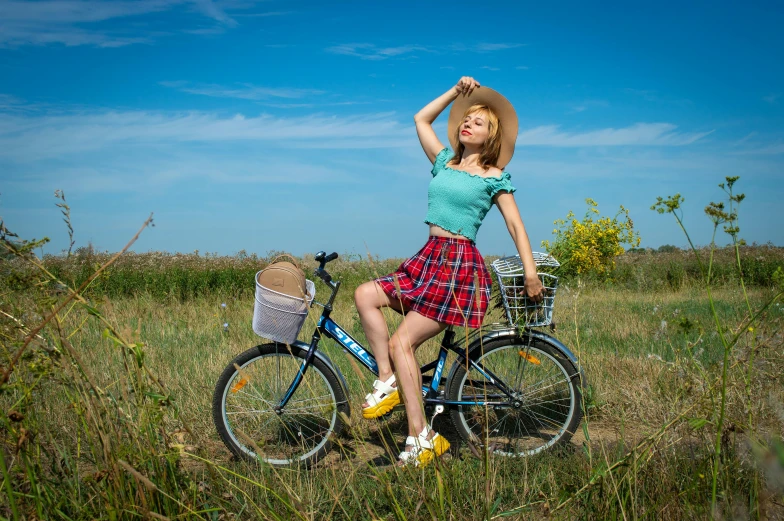 a woman in a plaid skirt sitting on her bike