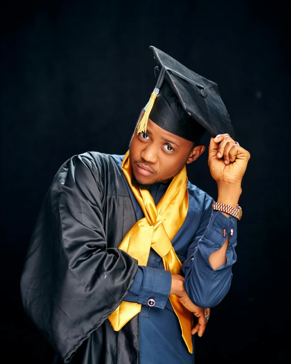 a male college student wearing a graduation hat and gown