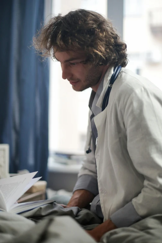 a person reading a book in a hospital room