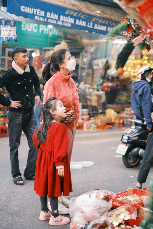 a  holds her hands up while looking at the man in the street