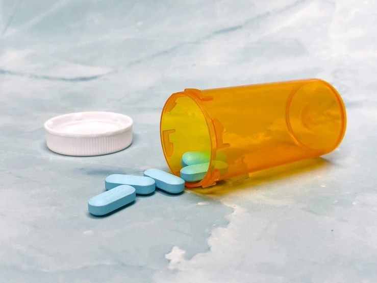 a pill and two pills sitting on top of a table