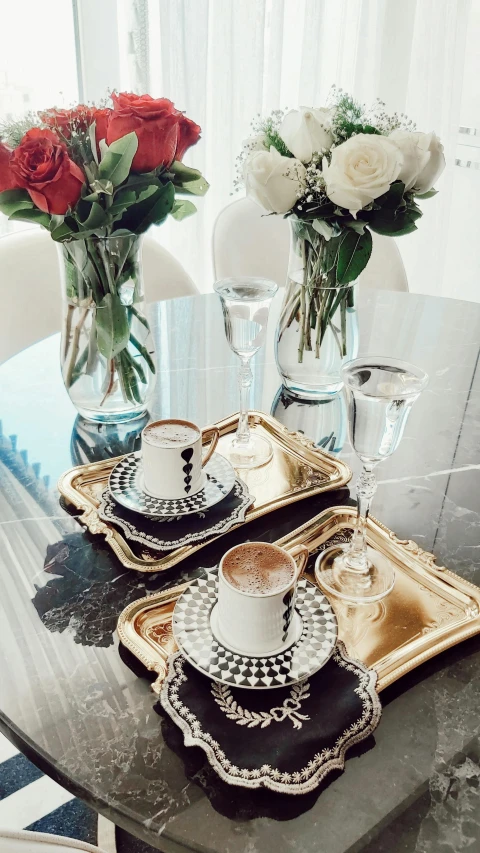 a table topped with plates covered in cups and saucers