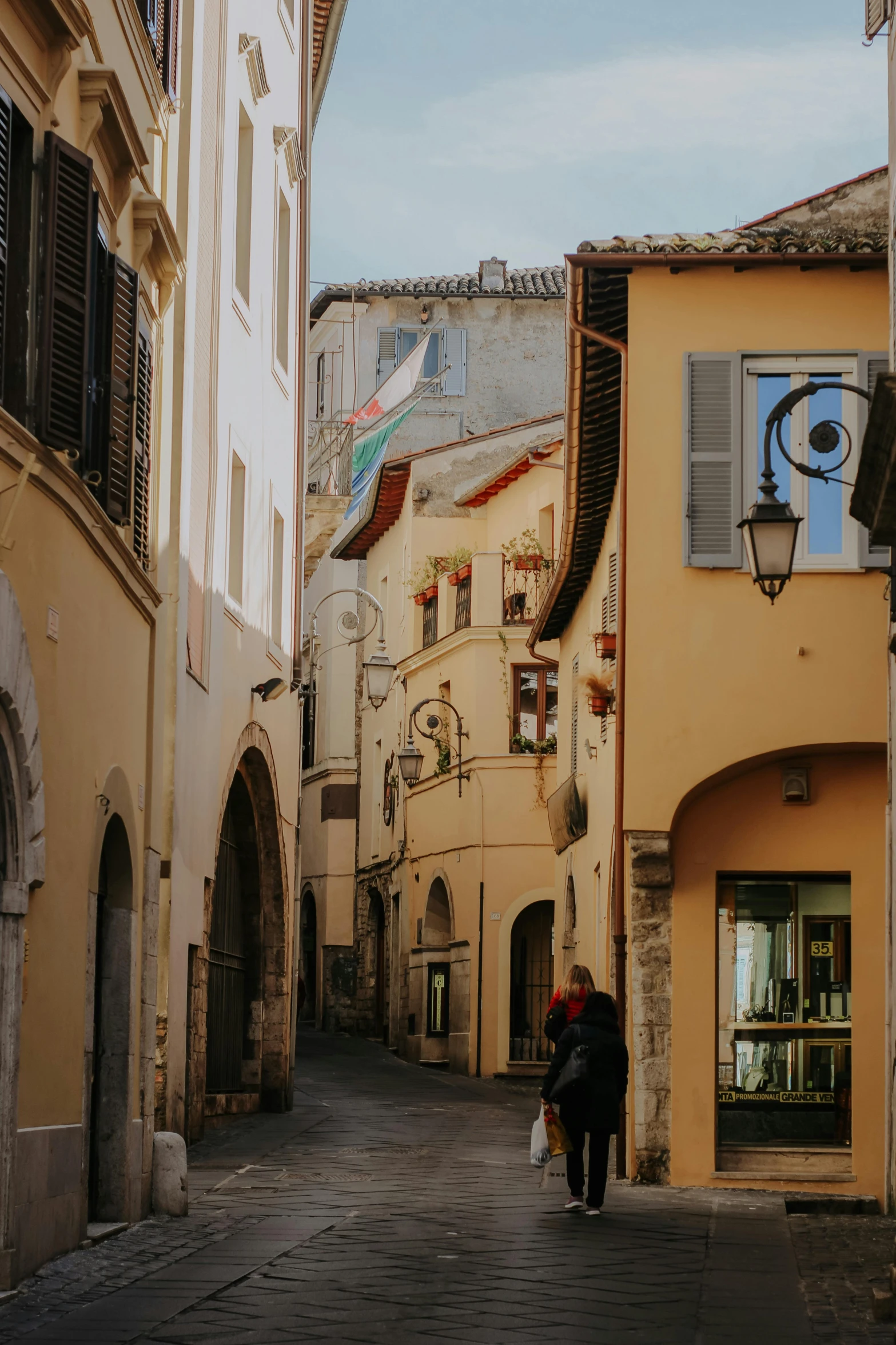 a couple is walking together on an alley way