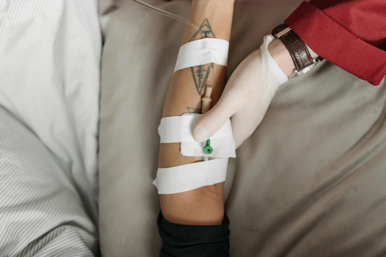 a person with bandages on their arms wrapped in plastic