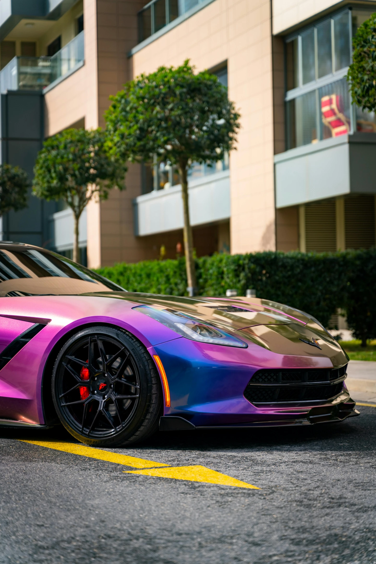 a purple car is parked on the side of the road