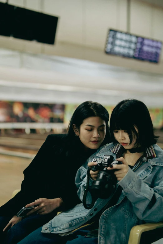 a woman standing next to a man in a bowling court