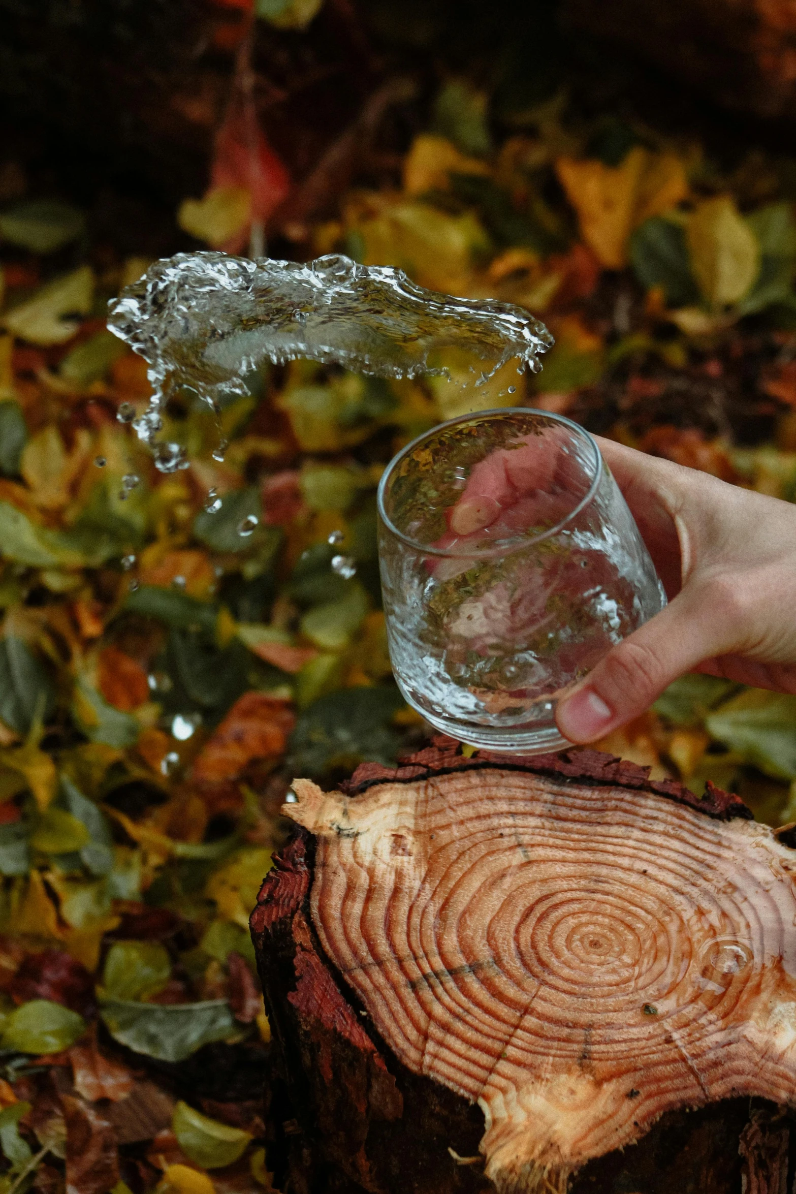 a man is holding an object and spouting water into the cup