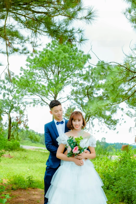 two people posing for a po in the woods