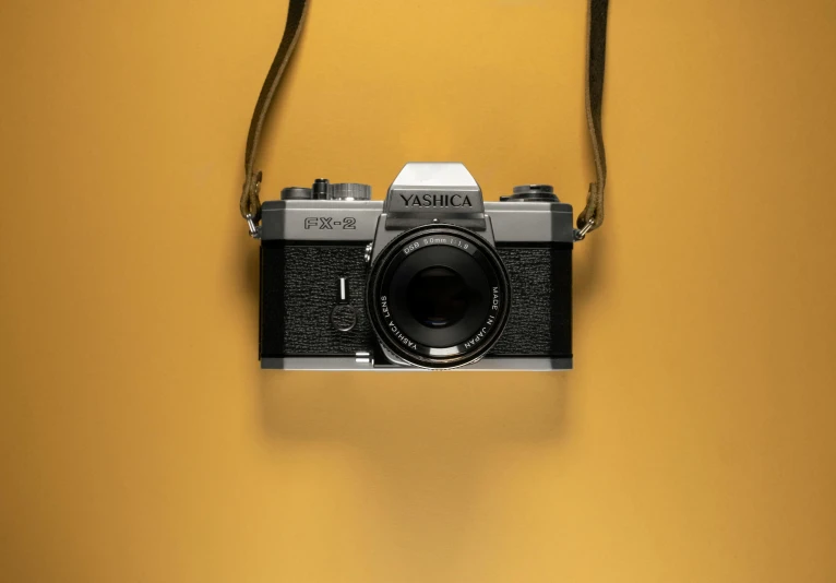 an old fashioned camera is hanging from a hook