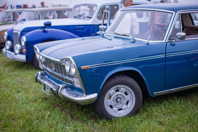 antique cars are parked on the grass with others