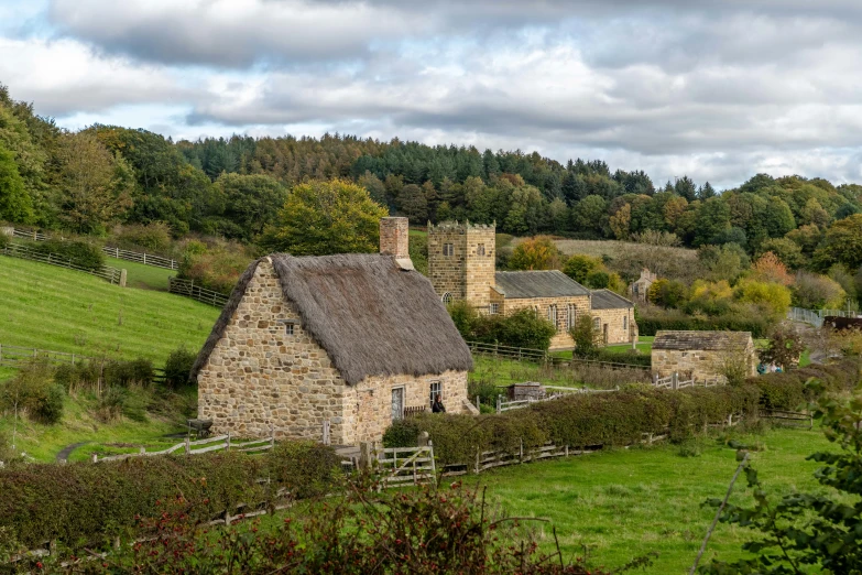 an old stone house on top of a hill