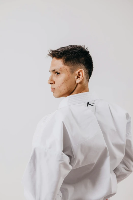 a man is looking forward while wearing a white jacket