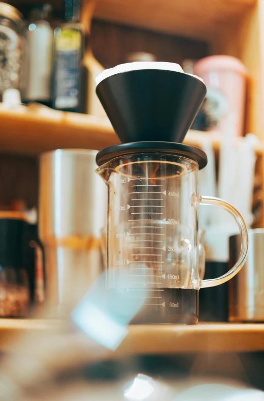 an image of a coffee pot next to a cup