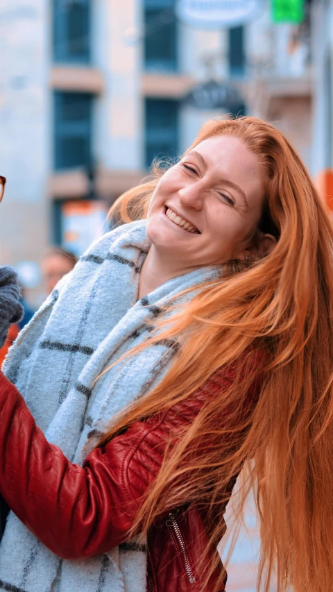 a woman holds her hair and poses for the camera