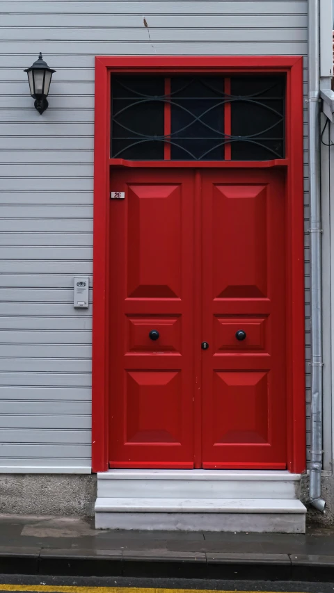 an image of a red door outside of a building