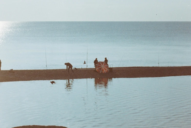 some people with a large clock on the shore