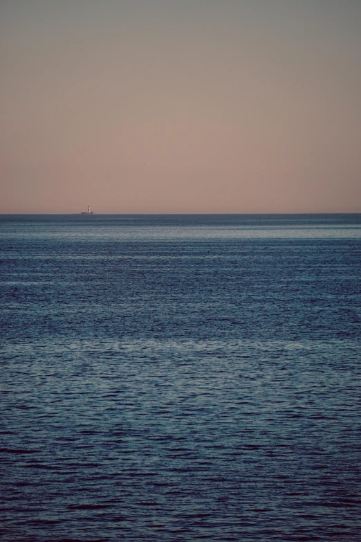 an ocean scene, with water and a boat