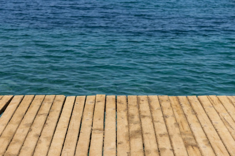 the wooden boards are on the water near the water