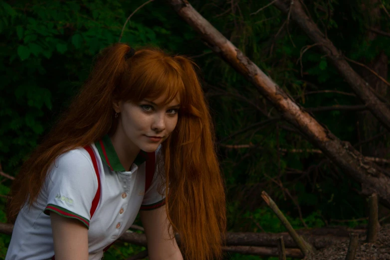 a woman with long red hair wearing a white shirt