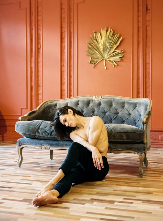 a woman is sitting on a couch by herself