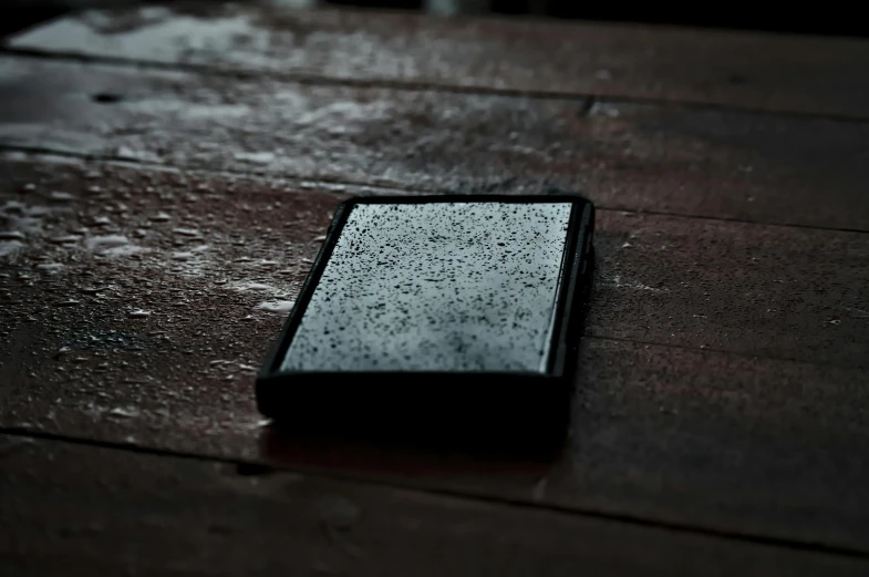 a black and white piece of wood sitting on the ground