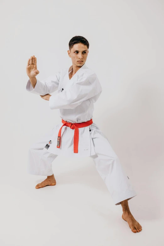 a man wearing a white suit doing karate