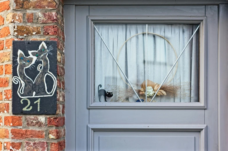 an image of a door with a cat drawing on the window