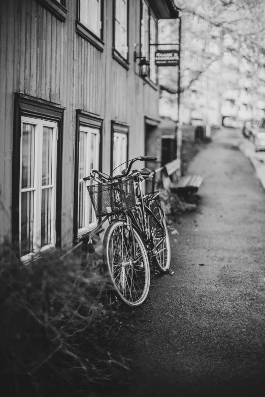 bicycles are  to a wooden pole in front of a building